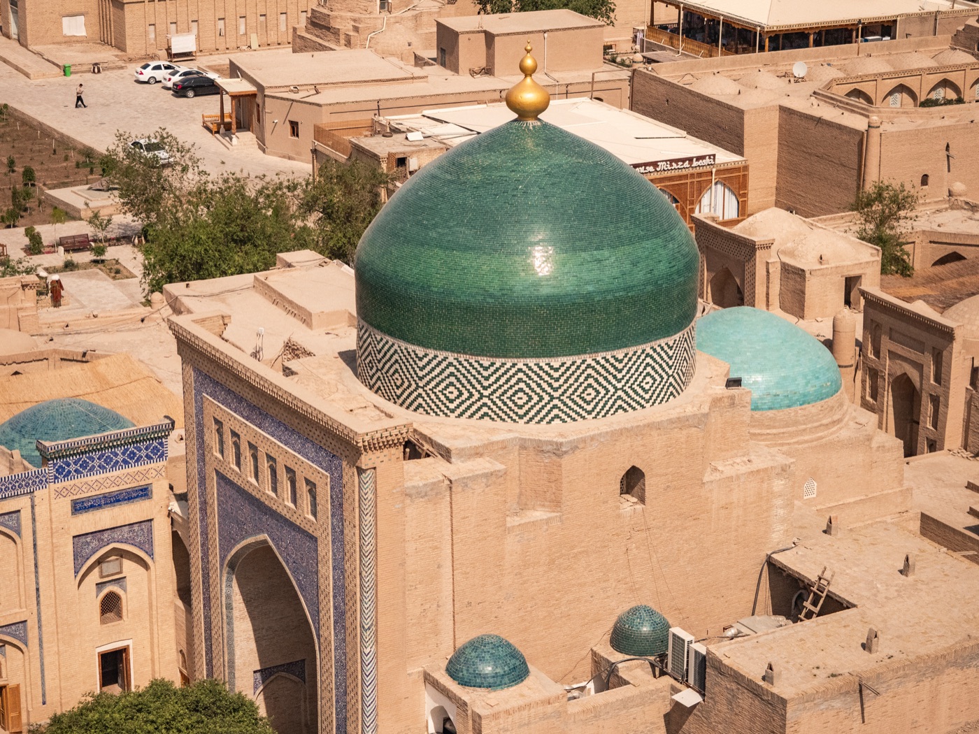 Elevated view over Khiva's old town rooftops and the green dome of the Pahlavan Mahmud Mausoleum